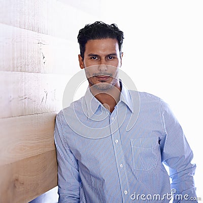Businessman, portrait and confident professional by wood background and confidence in career in workplace. Designer Stock Photo