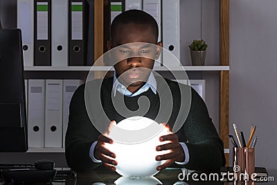 Businessman Predicting Future With Crystal Ball Stock Photo