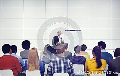 Businessman Presenting in Front of Audience Stock Photo