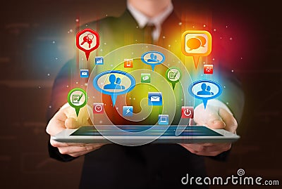 Businessman presenting modern tablet with colorful social signs Stock Photo