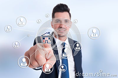 Businessman presses smart home icon Stock Photo
