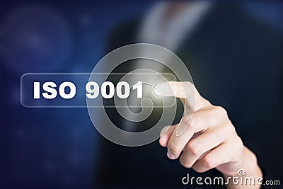 Businessman pressing a ISO 9001 concept button. Stock Photo