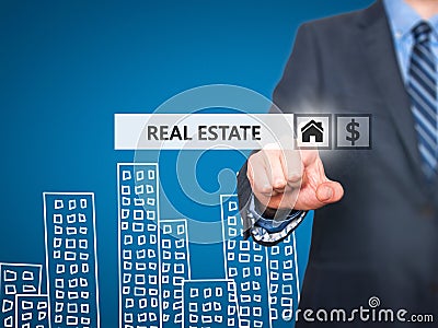 Businessman pressing real estate button on virtual screens Stock Photo