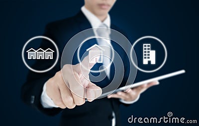 Businessman pressing real estate icons on screen. Business investment in real estate, town house, single home and condominium Stock Photo