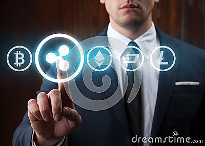 Businessman pressing ripple icon choosing from other cryptocurrency. Bitcoin, ripple, litecoin, dash, ethereum Editorial Stock Photo