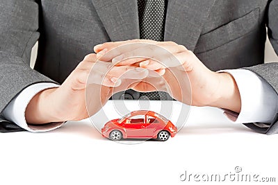 Businessman protect with his hands a red car, concept for insurance, buying, renting, fuel or service and repair costs Stock Photo