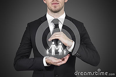 Businessman protecting family Stock Photo