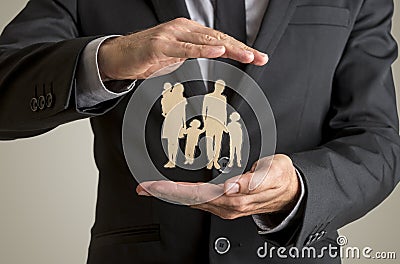 Businessman protecting family silhouette with a father mother ba Stock Photo