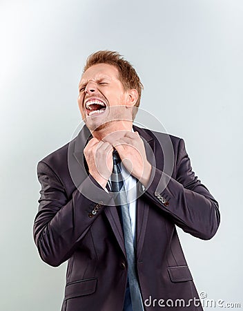 Businessman pulling his shirt of the neck Stock Photo