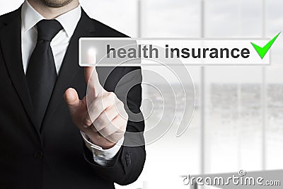 Businessman pushing button health insurance Stock Photo