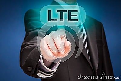 Businessman pushing finger on lte button Stock Photo