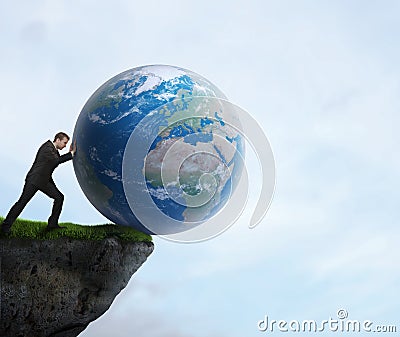 Businessman pushing planet Earth off a cliff Stock Photo