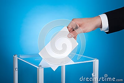 Businessman putting paper in election box Stock Photo