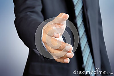 Businessman reaching his hand offering handshake Stock Photo