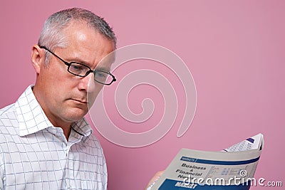 Businessman reading the financial newspaper Stock Photo