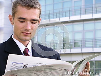 Businessman reading newspaper Stock Photo