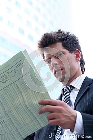 Businessman reading newspaper Stock Photo