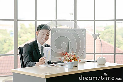 Businessman reading report to understand more about current business situation Stock Photo