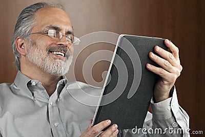 Businessman Reading From a Tablet Stock Photo