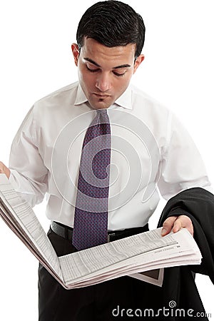 Businessman reads share prices in newspaper Stock Photo