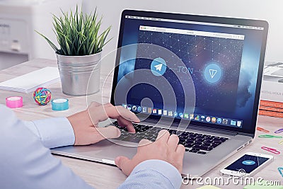 Businessman reads Telegram Open Network TON white paper on ICO rating website Editorial Stock Photo