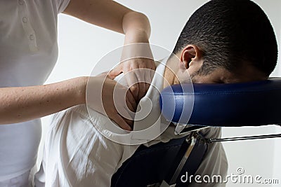 Businessman receiving shiatsu on a massage chair Stock Photo