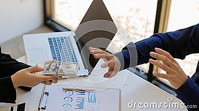 Businessman refused money by his partner Offer money for anti-bribery and corruption ideas. Stock Photo