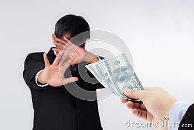 Businessman refuses to receive money - no bribery and corruption concept. Stock Photo