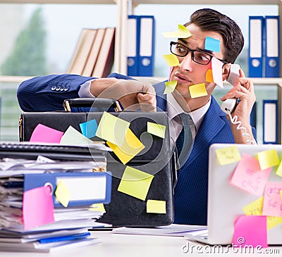 Businessman with reminder notes in multitasking concept Stock Photo