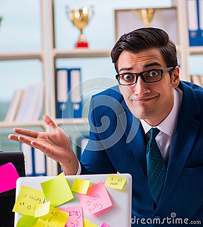 Businessman with reminder notes in multitasking concept Stock Photo