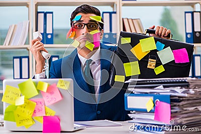 The businessman with reminder notes in multitasking concept Stock Photo