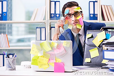 The businessman with reminder notes in multitasking concept Stock Photo