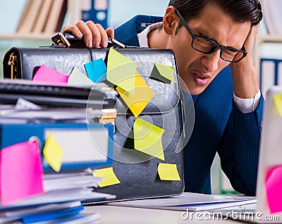 Businessman with reminder notes in multitasking concept Stock Photo