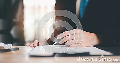 Businessman reviewing and managing business documents and agreements online ,signing a business contract approval of contract Stock Photo