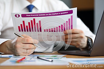 Businessman reviews statistical financial report Stock Photo