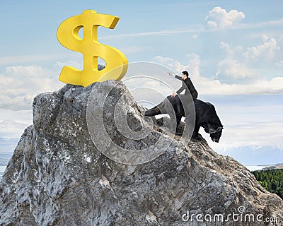 Businessman riding bear pursuing gold dollar sign on mountain pe Stock Photo