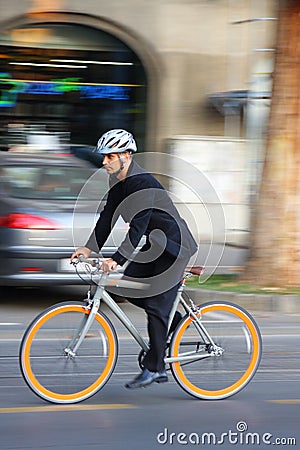 Businessman riding a bicycle Stock Photo