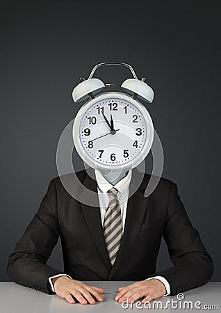 Businessman with ringing alarm clock instead of head, time limit Stock Photo