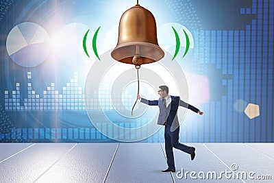 Businessman ringing the bell in case of danger Stock Photo