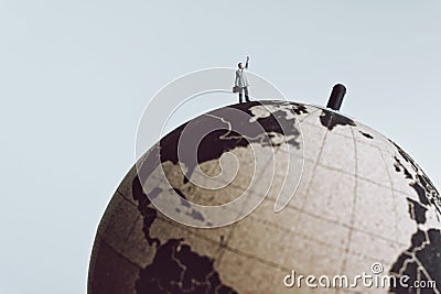 Businessman rise hand up to call for something while standing on Earth globe Stock Photo