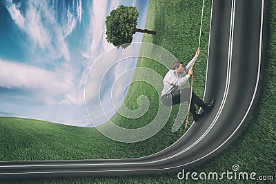 Businessman climbs a road bent upwards. Achievement business goal and difficult career concept Stock Photo
