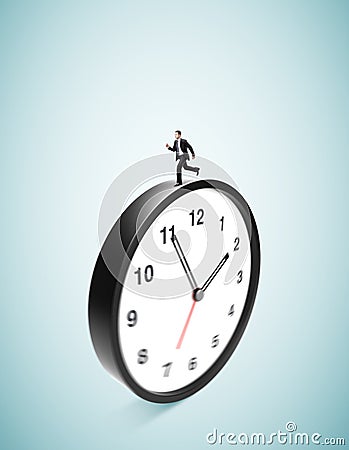 Businessman runing on clock Stock Photo