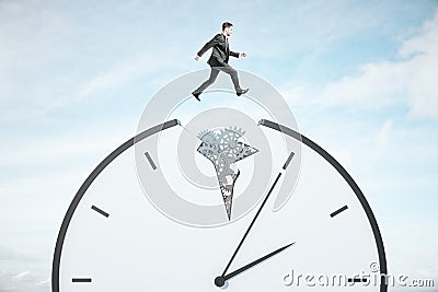 Businessman runing on gear cogwheel clock Stock Photo