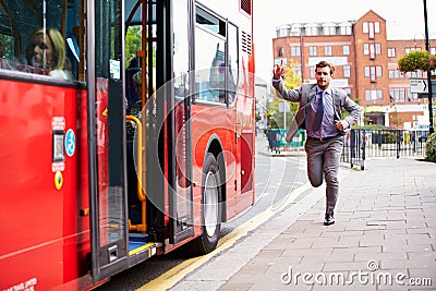 Businessman Running To Catch Bus Stop Stock Photo