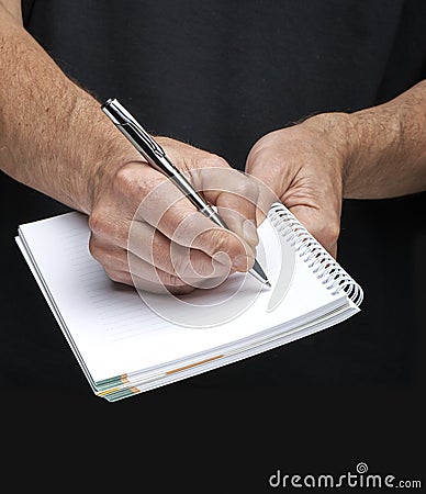 Businessman's hand with a gilded pen writing somet Stock Photo