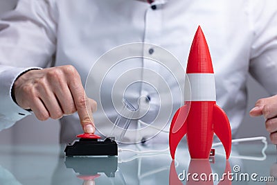 Businessman`s Hand Launching Rocket Stock Photo