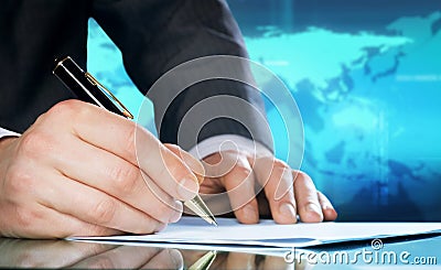 Businessmans hand with a pen Stock Photo