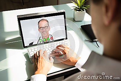 Businessman videoconferencing with doctor on laptop Stock Photo