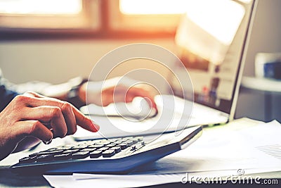 Businessman`s hands with calculator at the office and Financial data Cost Economic Stock Photo