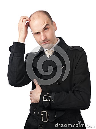 Businessman scratches his head in confusion Stock Photo